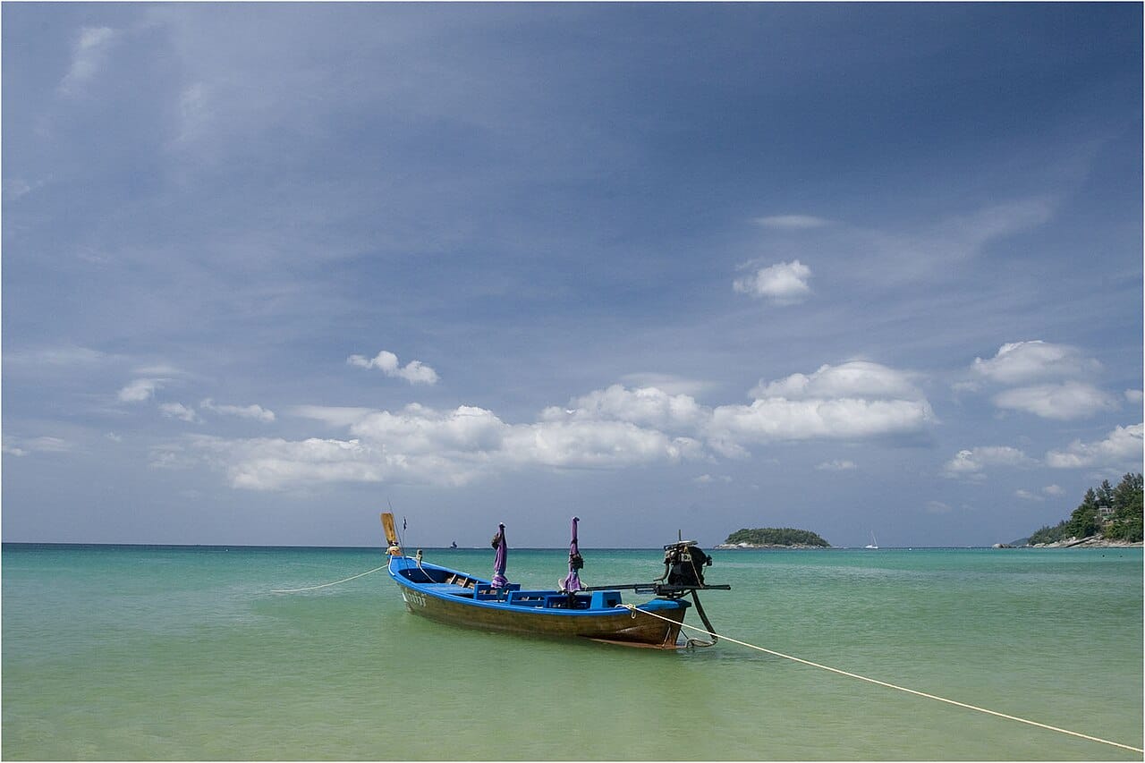 Longtail boat on the turquoise water of Kata Noi beach, Phuket